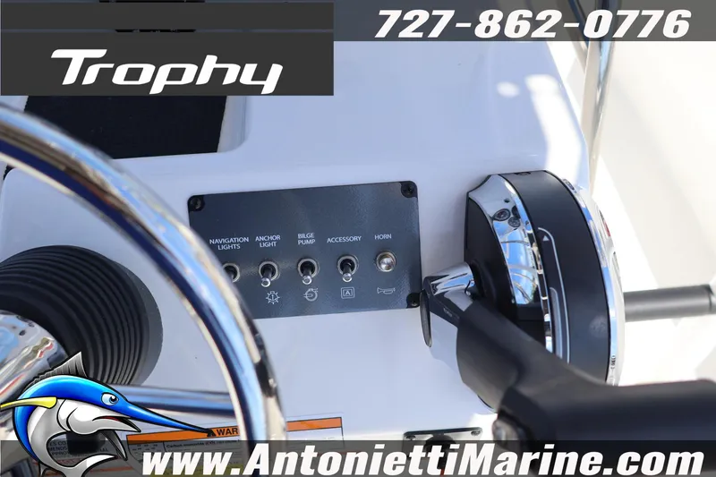 Slide: The Image of Control panel of 2026 Bayliner Trophy T18 boat with steering wheel and throttle. - 23