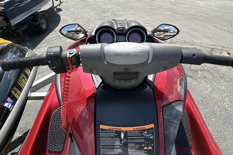 Slide: The Image of 2011 Yamaha WaveRunner FZS dashboard and handlebars, featuring mirrors and warning labels. - 3