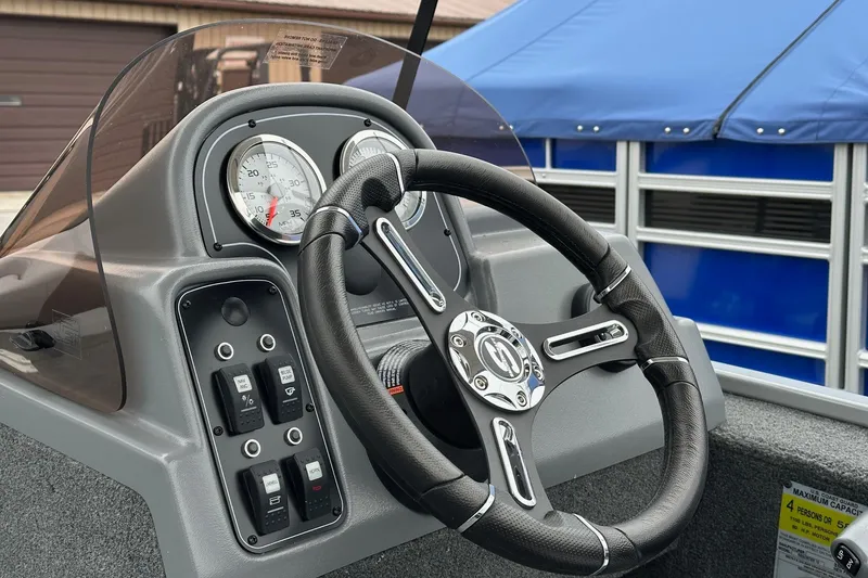 Slide: The Image of 2025 Smoker Craft Resorter 151 boat dashboard with steering wheel and gauges. - 12