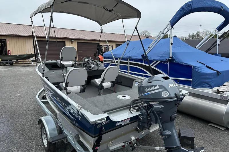 Slide: The Image of 2025 Smoker Craft Resorter 151 boat with Yamaha 20 engine, parked on trailer. - 3