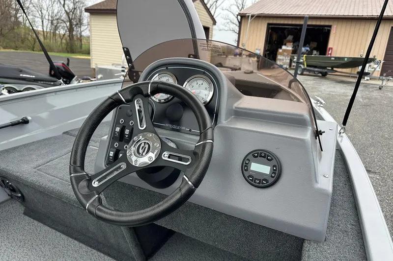Slide: The Image of 2025 Smoker Craft Resorter 151 boat dashboard with steering wheel and gauges. - 5