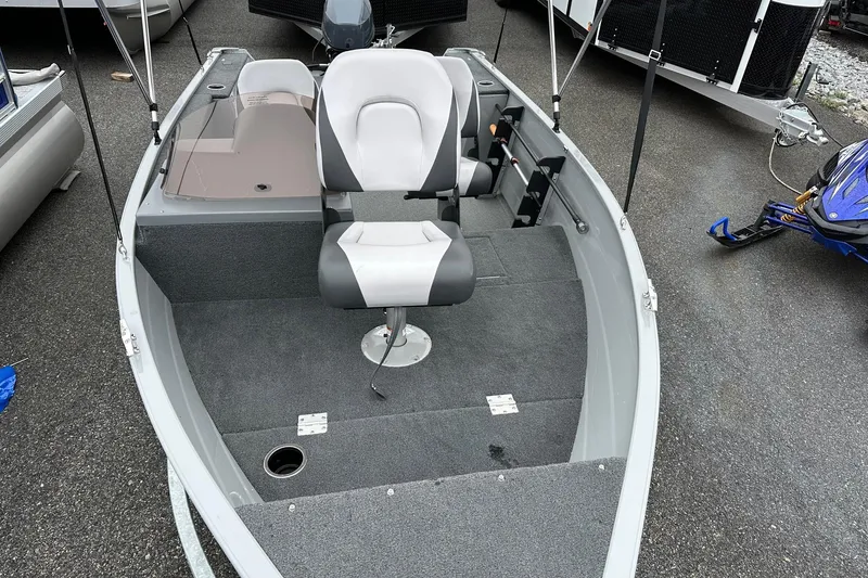 Slide: The Image of 2025 Smoker Craft Resorter 151 boat interior with seating and carpeted deck. - 7