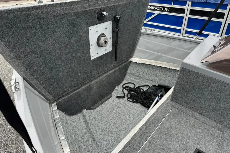 Slide: The Image of 2025 Smoker Craft Resorter 151 boat interior with carpeted flooring and storage area. - 9