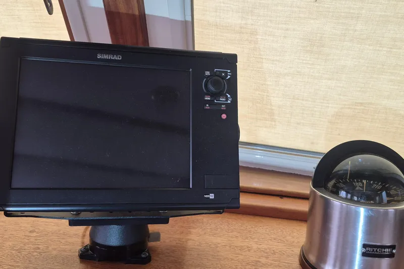 Slide: The Image of Simrad navigation system and Ritchie compass on 1988 Holland Wesmac-Foley Flybridge Cruiser. - 100