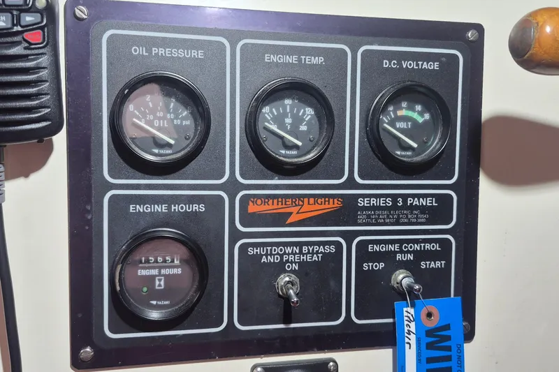 Slide: The Image of Control panel of 1988 Custom Holland Wesmac-Foley Flybridge Cruiser with gauges and switches. - 101