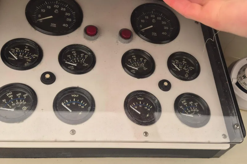 Slide: The Image of Instrument panel of 1988 Custom Holland Wesmac-Foley Flybridge Cruiser with gauges and dials. - 102