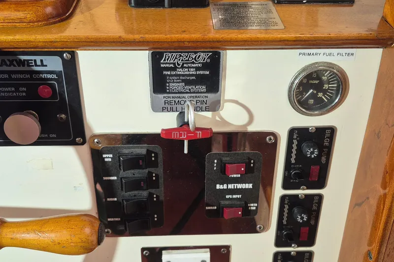 Slide: The Image of Control panel of 1988 Custom Holland Wesmac-Foley Flybridge Cruiser with switches and gauges. - 103