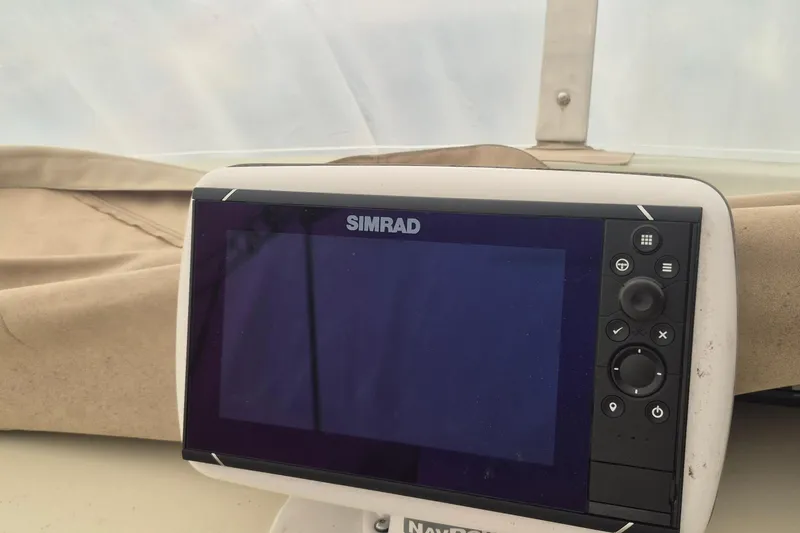 Slide: The Image of Simrad navigation system on 1988 Holland Wesmac-Foley Flybridge Cruiser, featuring a sleek design. - 106