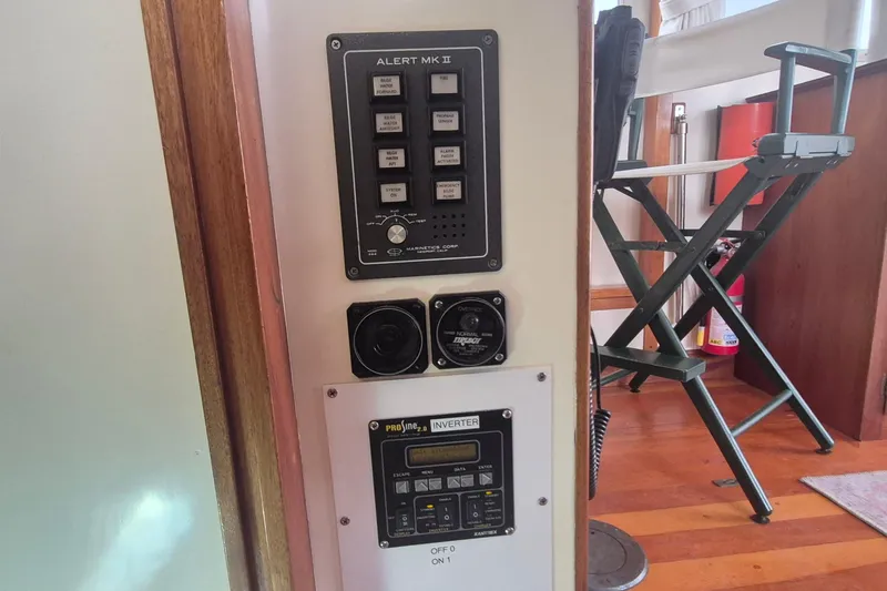 Slide: The Image of Control panel on 1988 Custom Holland Wesmac-Foley Flybridge Cruiser, featuring Alert MK II and inverter. - 108