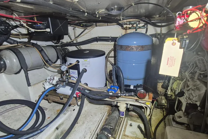 Slide: The Image of Engine room of 1988 Custom Holland Wesmac-Foley Flybridge Cruiser with mechanical components. - 110