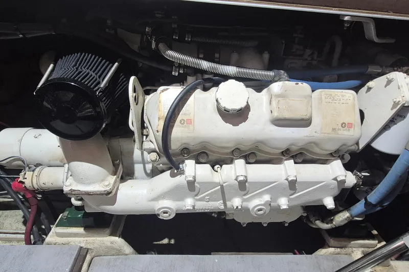 Slide: The Image of Engine of 1988 Custom Holland Wesmac-Foley Flybridge Cruiser, showcasing mechanical components. - 115