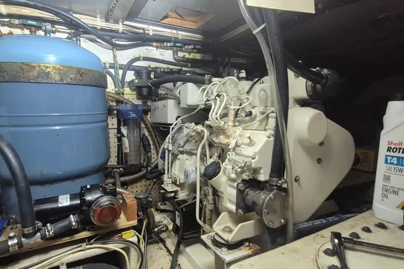 Slide: The Image of Engine room of 1988 Custom Holland Wesmac-Foley Flybridge Cruiser with machinery and components. - 118