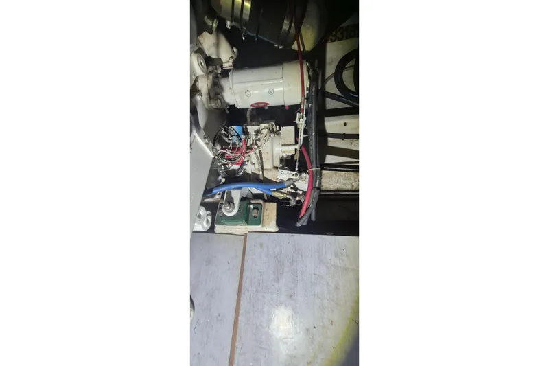 Slide: The Image of Engine compartment of 1988 Custom Holland Wesmac-Foley Flybridge Cruiser with visible wiring and components. - 119