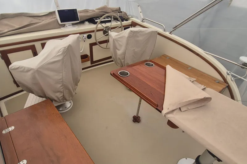 Slide: The Image of 1988 Holland Wesmac-Foley Flybridge Cruiser interior with covered seats and wooden table. - 122