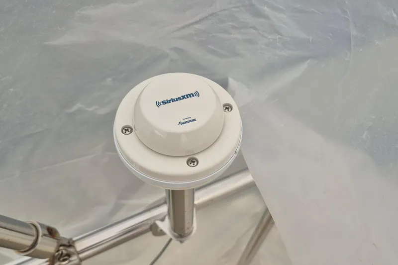 Slide: The Image of SiriusXM antenna on 1988 Custom Holland Wesmac-Foley Flybridge Cruiser, mounted on metal railing. - 126