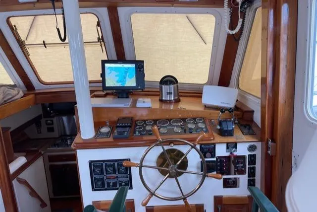 Slide: The Image of 1988 Holland Wesmac-Foley Flybridge Cruiser helm with navigation equipment. - 13