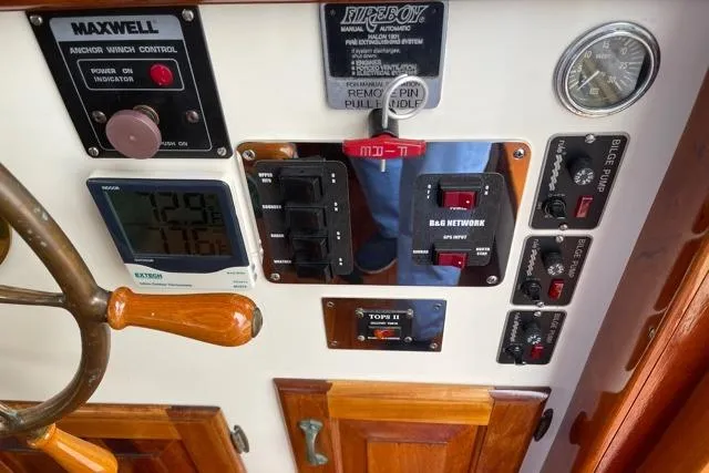 Slide: The Image of 1988 Holland Wesmac-Foley Flybridge Cruiser control panel with instruments. - 14