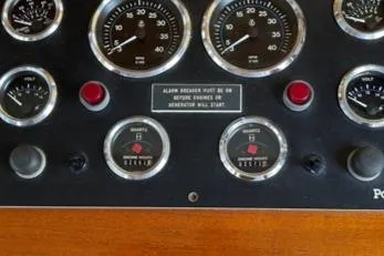 Slide: The Image of Dashboard of a 1988 Holland Wesmac-Foley Flybridge Cruiser with gauges. - 19