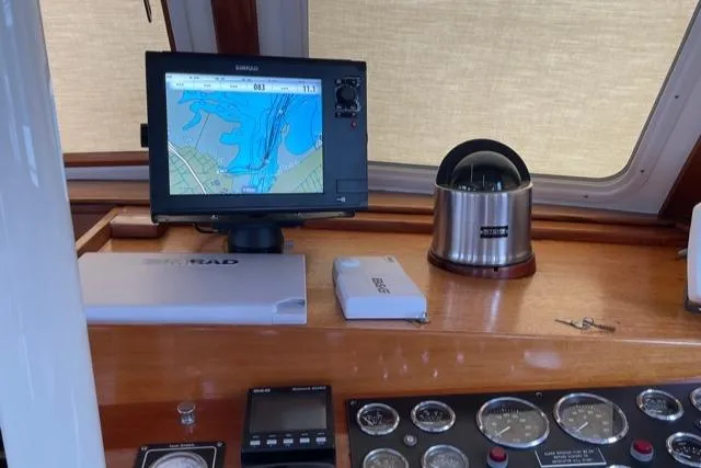 Slide: The Image of 1988 Holland Wesmac-Foley Flybridge Cruiser dashboard with navigation equipment. - 21