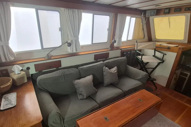 Slide: The Image of Interior of 1988 Holland Wesmac-Foley Flybridge Cruiser with sofa and director's chair. - 3