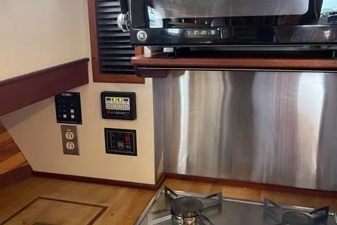 Slide: The Image of Interior of 1988 Holland Wesmac-Foley Flybridge Cruiser with stove and microwave. - 30