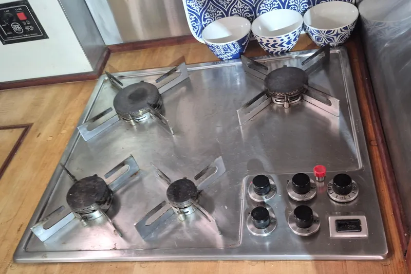 Slide: The Image of Stainless steel gas stove with four burners on a 1988 Holland Wesmac-Foley Flybridge Cruiser. - 33