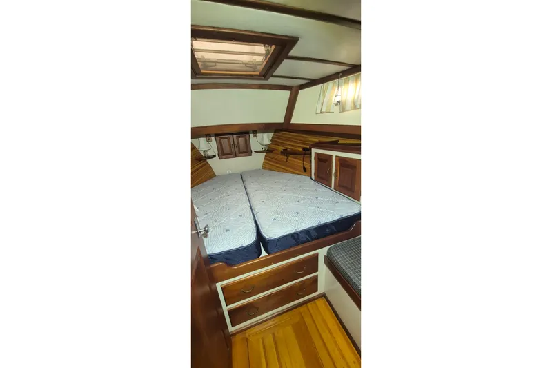 Slide: The Image of 1988 Custom Holland Wesmac-Foley Flybridge Cruiser cabin with twin beds and wooden interior. - 36