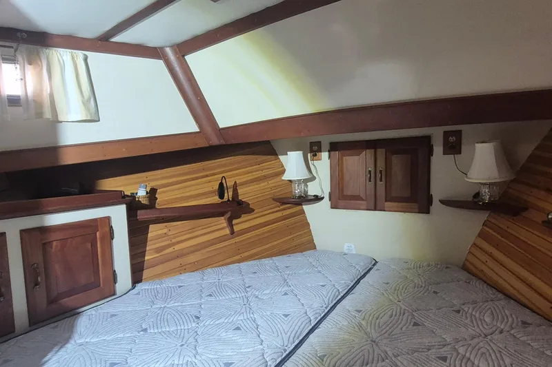 Slide: The Image of Cozy cabin interior of 1988 Holland Wesmac-Foley Flybridge Cruiser with wood accents and twin beds. - 39