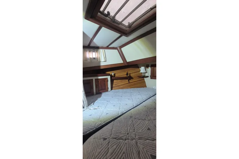 Slide: The Image of Interior cabin of 1988 Custom Holland Wesmac-Foley Flybridge Cruiser with skylight and wood accents. - 43