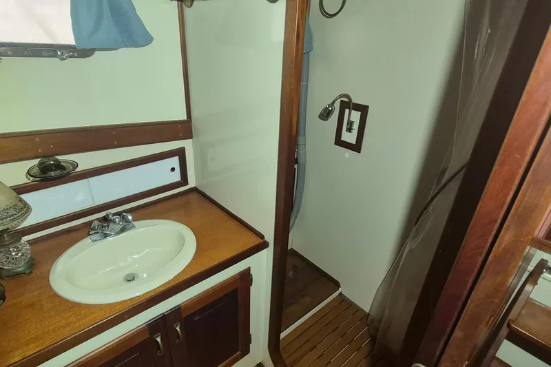 Slide: The Image of 1988 Custom Holland Wesmac-Foley Flybridge Cruiser bathroom with sink and shower. - 47