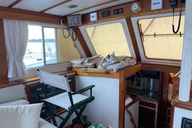 Slide: The Image of Interior of a 1988 Holland Wesmac-Foley Flybridge Cruiser with helm station. - 5