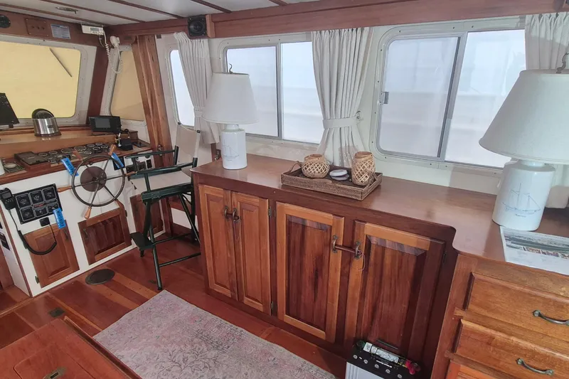 Slide: The Image of Interior of 1988 Custom Holland Wesmac-Foley Flybridge Cruiser with wooden cabinetry and nautical decor. - 6