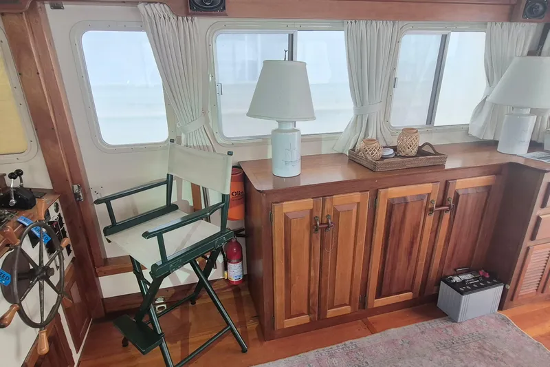 Slide: The Image of Interior of 1988 Holland Wesmac-Foley Flybridge Cruiser with wooden cabinetry and nautical decor. - 8