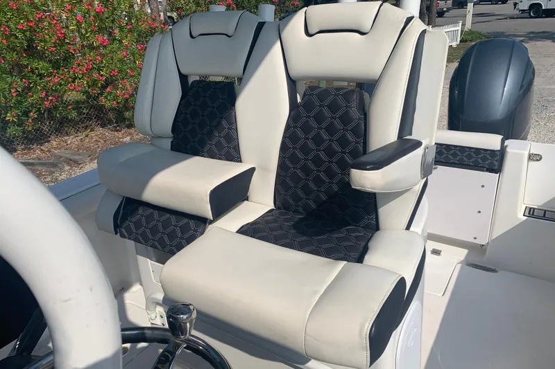 Slide: The Image of 2021 Tidewater 256 CC Adventure boat seats with black and white upholstery. - 12