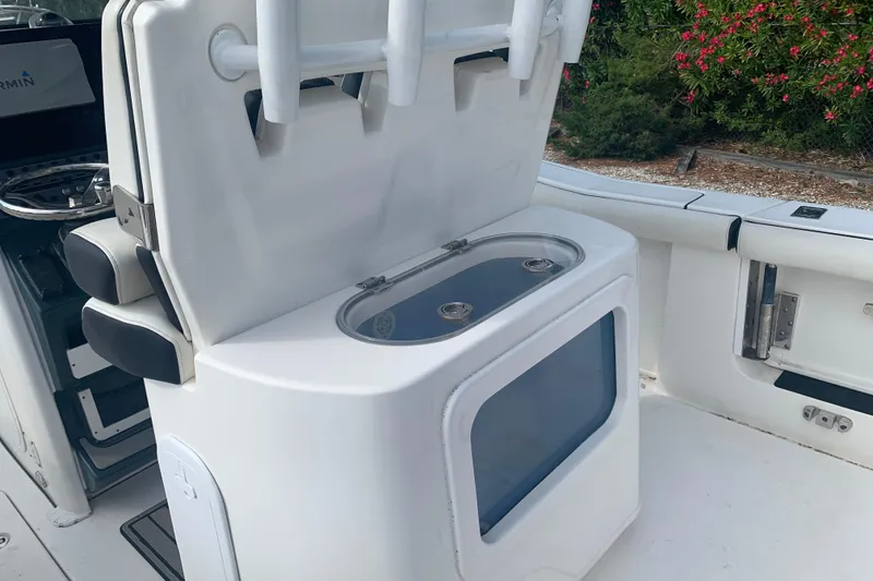 Slide: The Image of 2021 Tidewater 256 CC Adventure boat interior with rod holders and storage compartment. - 14