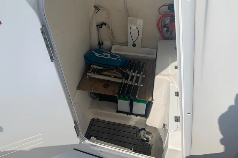 Slide: The Image of Storage compartment of 2021 Tidewater 256 CC Adventure boat with equipment and accessories. - 15