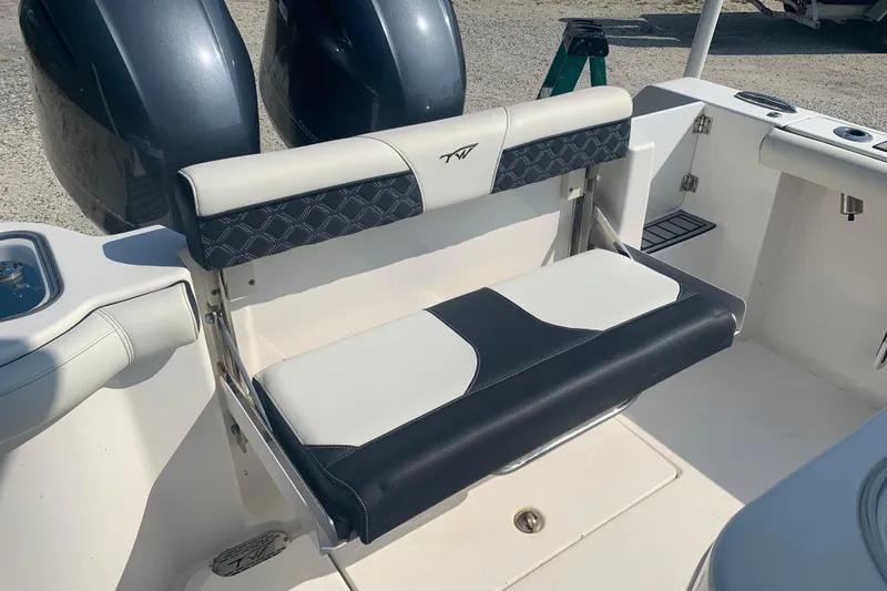 Slide: The Image of 2021 Tidewater 256 CC Adventure boat seat with dual engines in the background. - 19