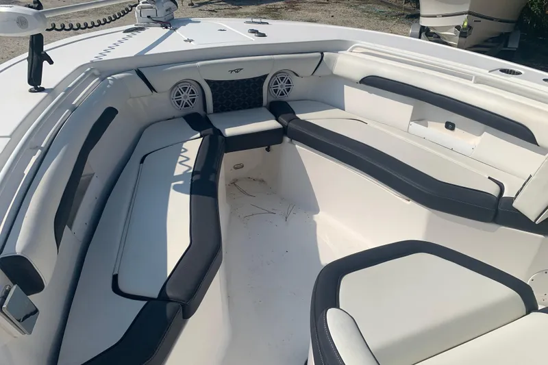 Slide: The Image of 2021 Tidewater 256 CC Adventure boat interior with cushioned seating and speakers. - 20