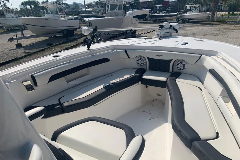 Slide: The Image of 2021 Tidewater 256 CC Adventure boat interior with cushioned seating and speakers. - 21