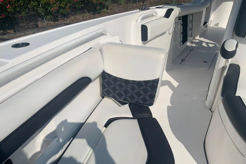Slide: The Image of Interior of 2021 Tidewater 256 CC Adventure boat with white and black seating. - 22