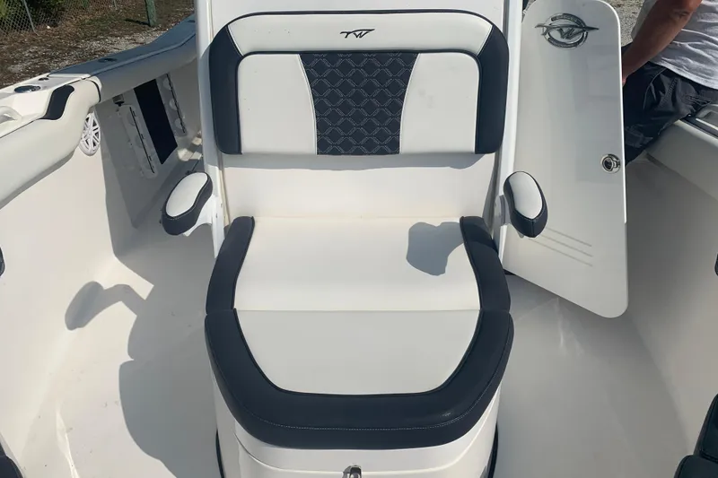 Slide: The Image of 2021 Tidewater 256 CC Adventure boat seat with black and white upholstery. - 24