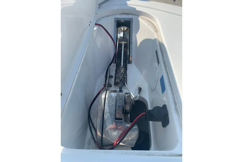 Slide: The Image of 2021 Tidewater 256 CC Adventure boat compartment with wiring and mechanical components. - 27
