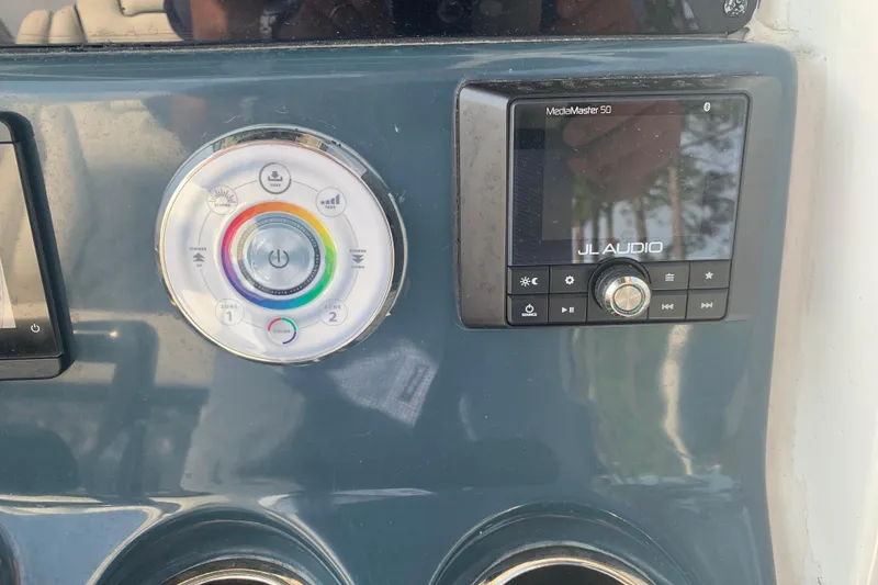 Slide: The Image of Control panel of 2021 Tidewater 256 CC Adventure with JL Audio system and LED settings. - 28