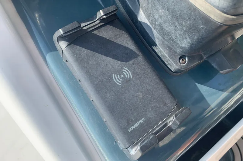 Slide: The Image of Wireless charging pad on 2021 Tidewater 256 CC Adventure boat dashboard. - 29