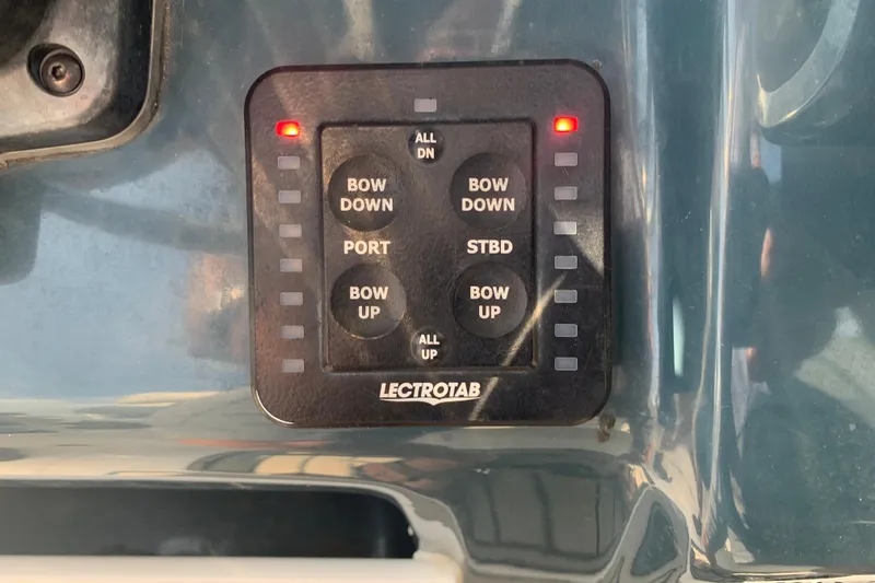 Slide: The Image of Control panel of a 2021 Tidewater 256 CC Adventure boat with Lectrotab trim tab switches. - 30