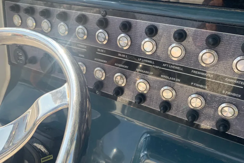 Slide: The Image of Control panel of 2021 Tidewater 256 CC Adventure boat with steering wheel. - 32