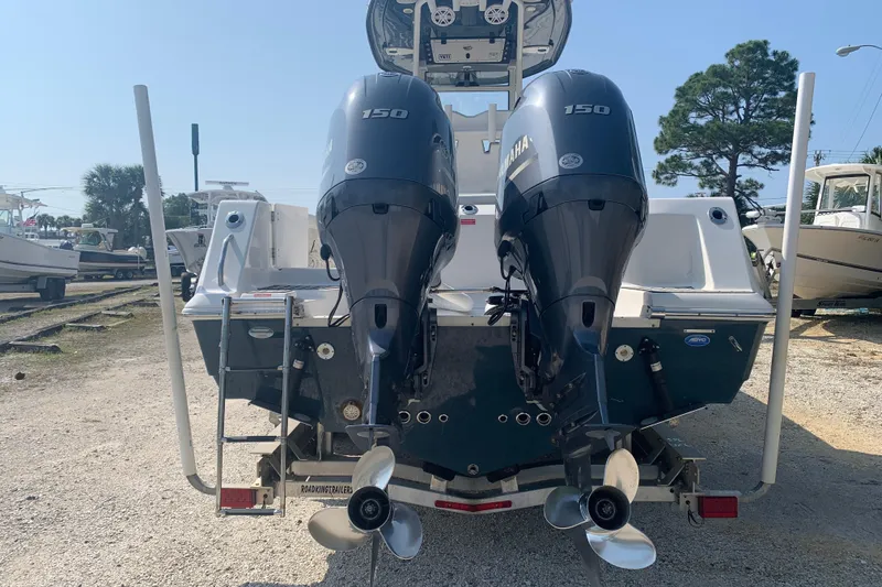 Slide: The Image of 2021 Tidewater 256 CC Adventure boat with dual Yamaha 150 engines, rear view. - 4