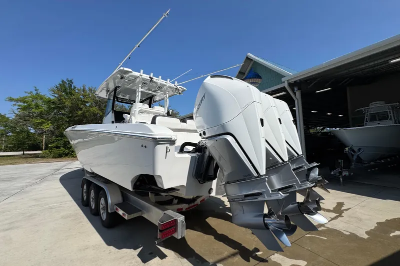 Slide: The Image of 2023 Fountain Bluewater 38 CC boat with triple outboard engines on a trailer. - 12