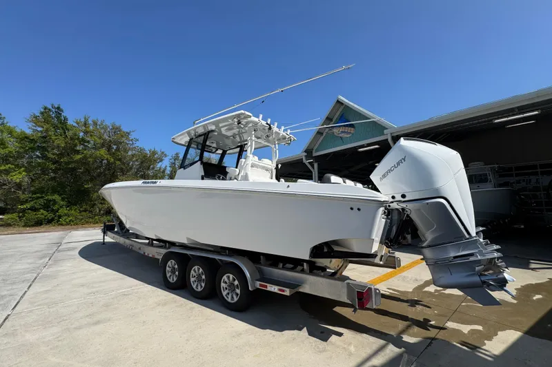 Slide: The Image of 2023 Fountain Bluewater 38 CC boat on trailer, featuring dual Mercury engines. - 13