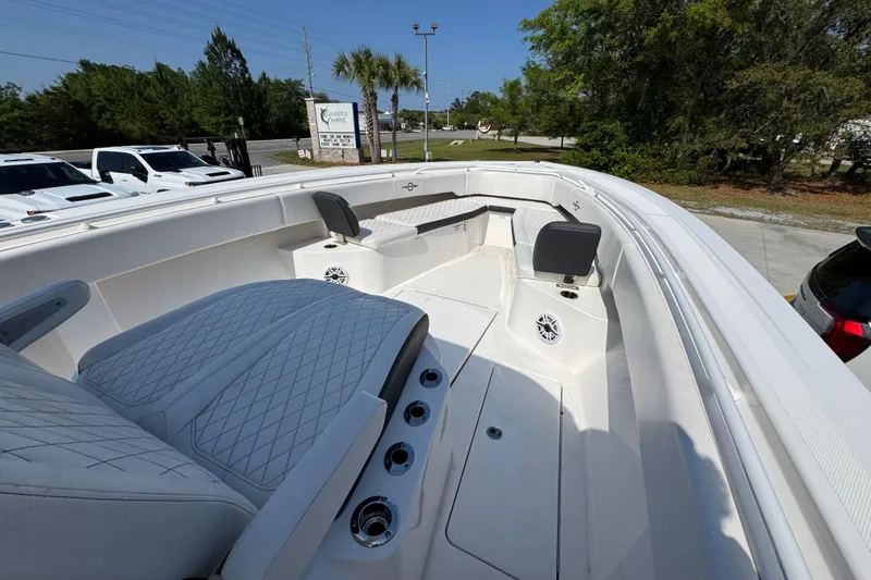 Slide: The Image of 2023 Fountain Bluewater 38 CC boat interior with seating and speakers. - 14